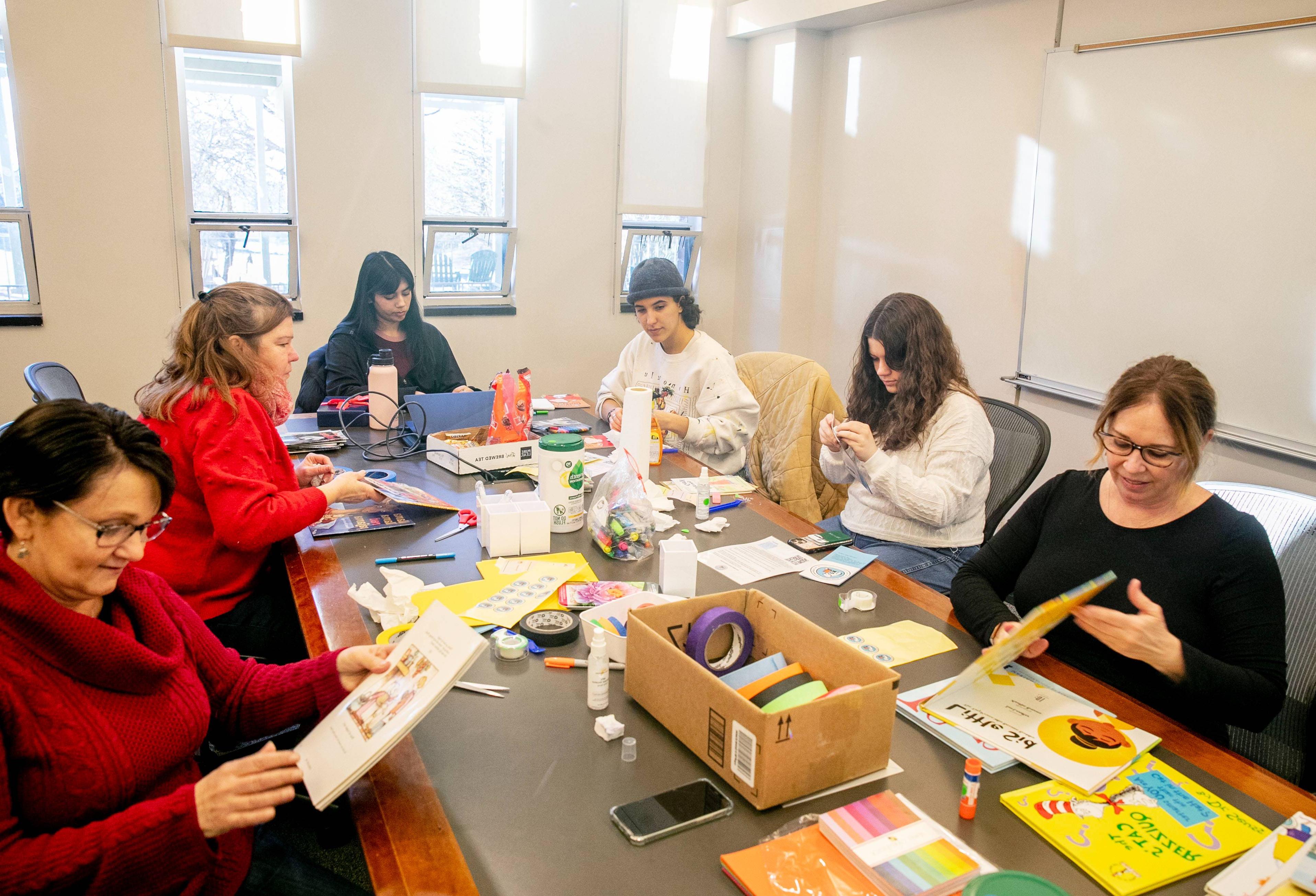 学生 repairing children's books for volunteer service